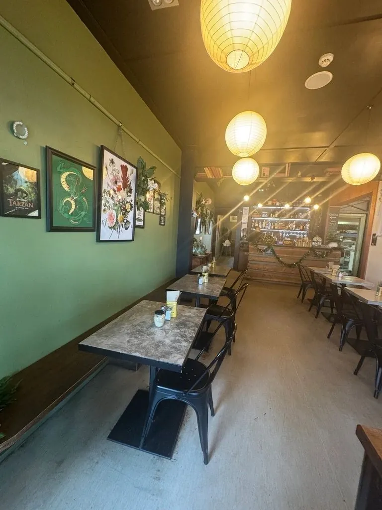 Green-walled café interior with paper lanterns